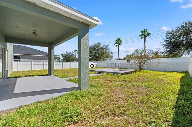 a view of a house with pool and chairs