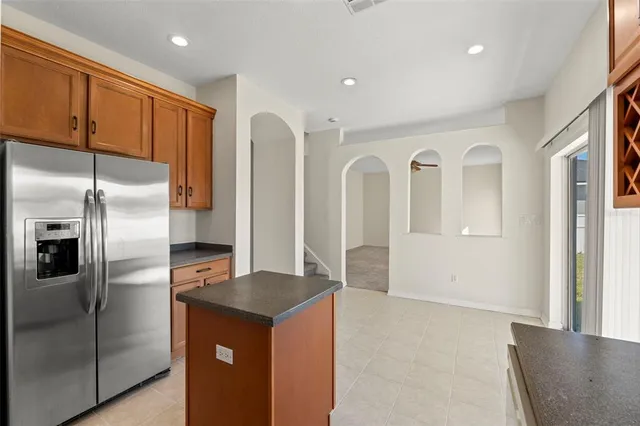 a kitchen with stainless steel appliances granite countertop a refrigerator and a sink