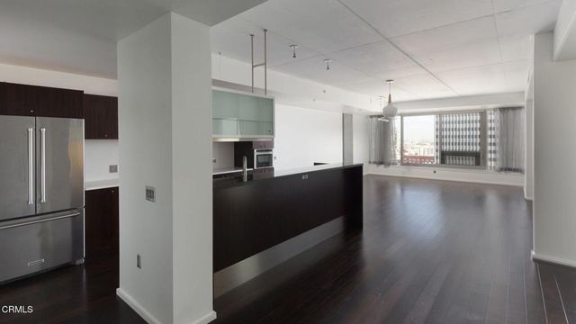 a kitchen with kitchen island a sink stove top oven and cabinets