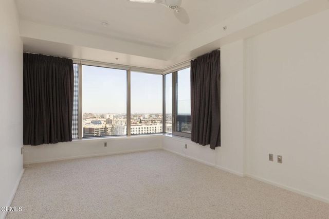 a bedroom with a large bed and a large window