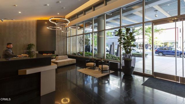 a living room with furniture and a mirror