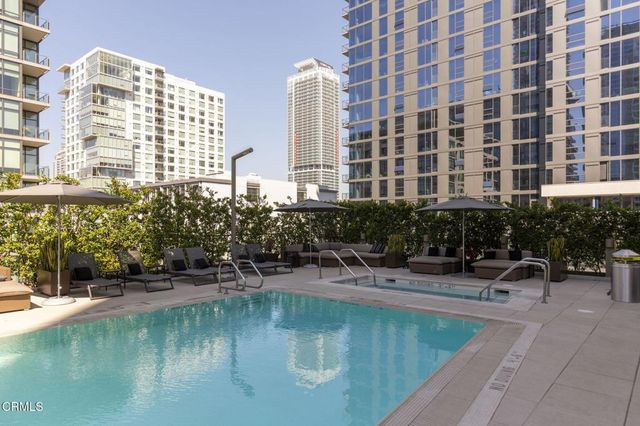 a view of a patio with a table and chairs and potted plants