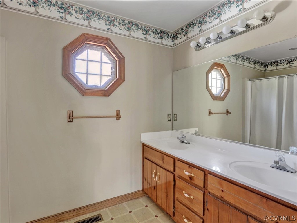 7936 Concho Road North Chesterfield, VA 23237 - Photo 16 of 24 a bathroom with a sink a mirror and a toilet