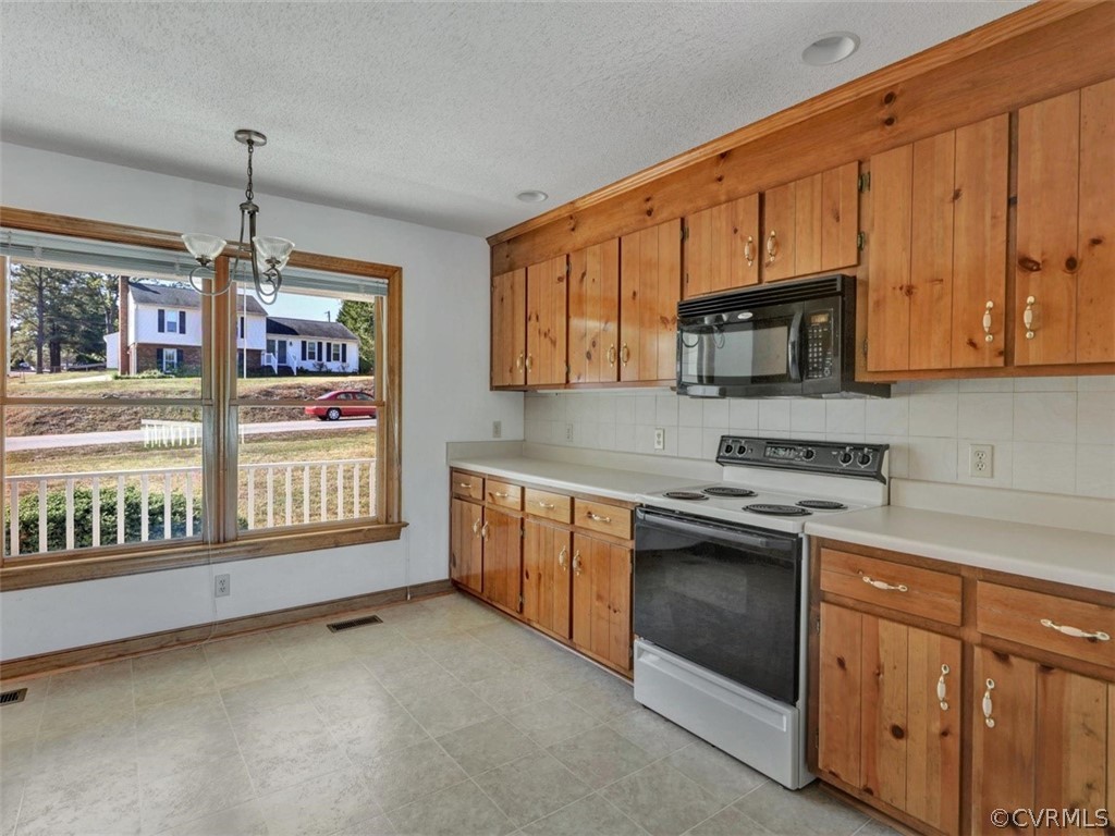 7936 Concho Road North Chesterfield, VA 23237 - Photo 10 of 24 a kitchen with stainless steel appliances granite countertop a stove sink and microwave