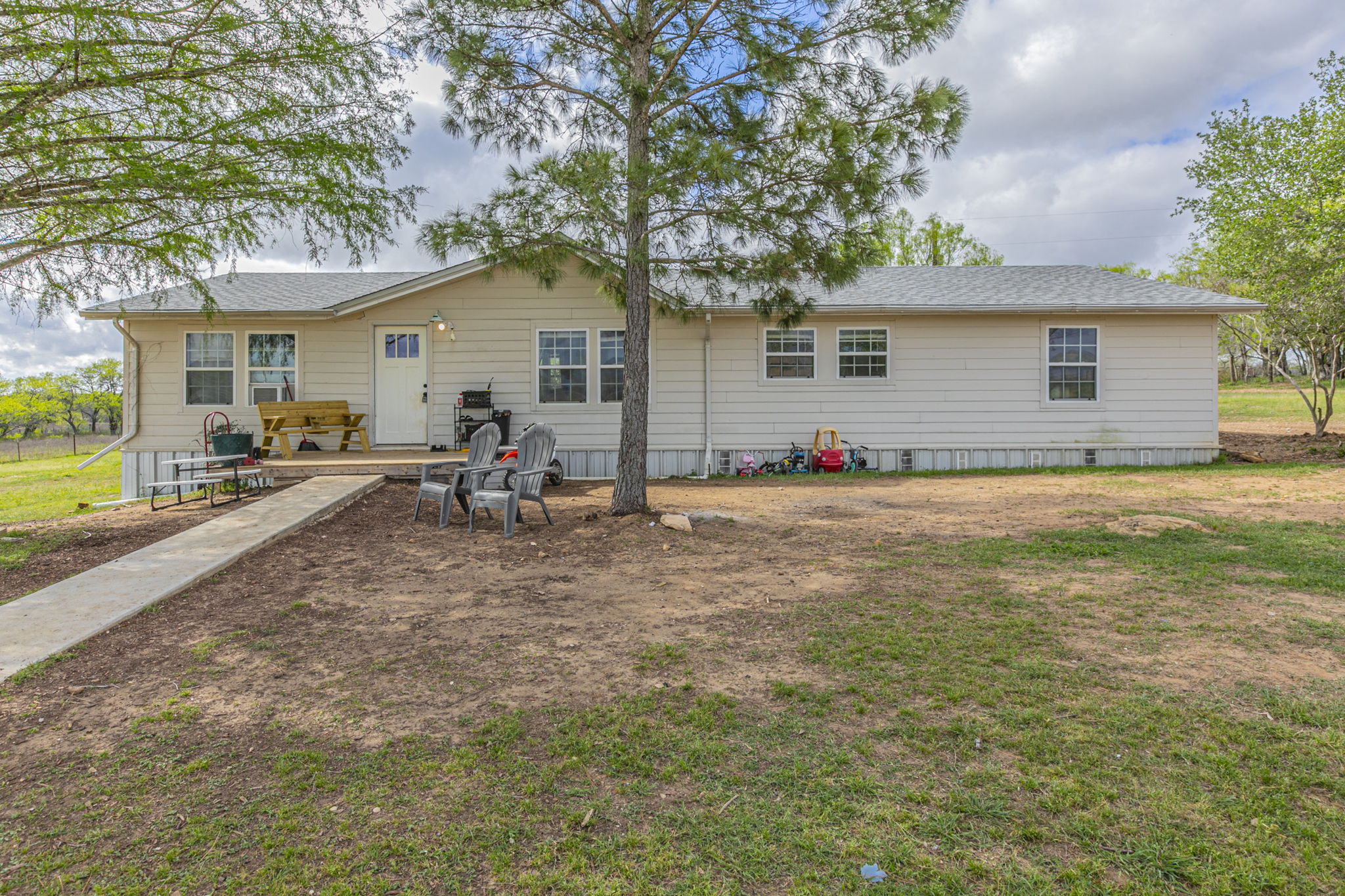 1767 Dowdy Road Seguin, TX 78155 - Photo 1 of 25 a backyard of a house with yard and outdoor seating
