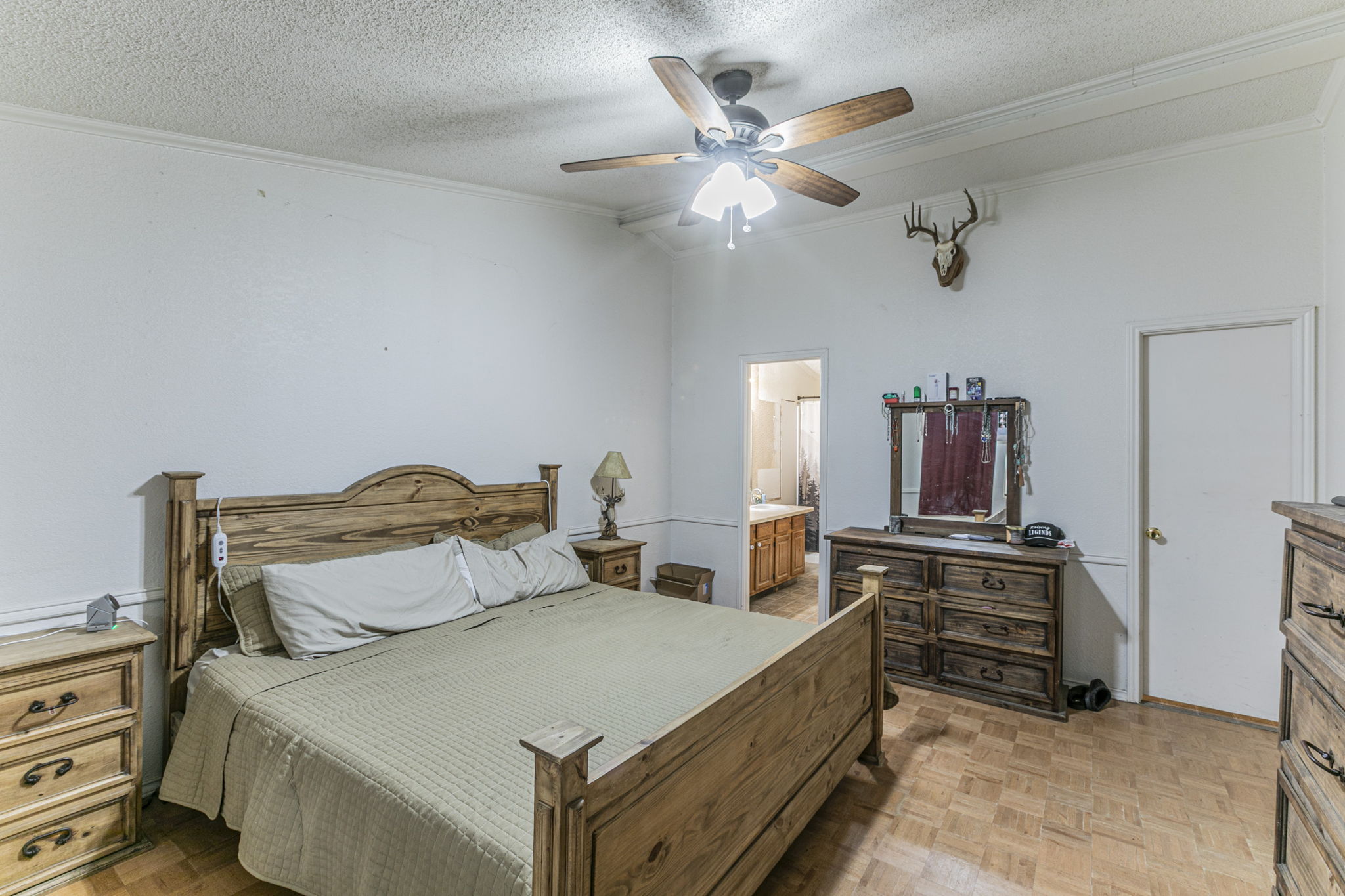 1767 Dowdy Road Seguin, TX 78155 - Photo 13 of 25 a bedroom with a bed and a chandelier