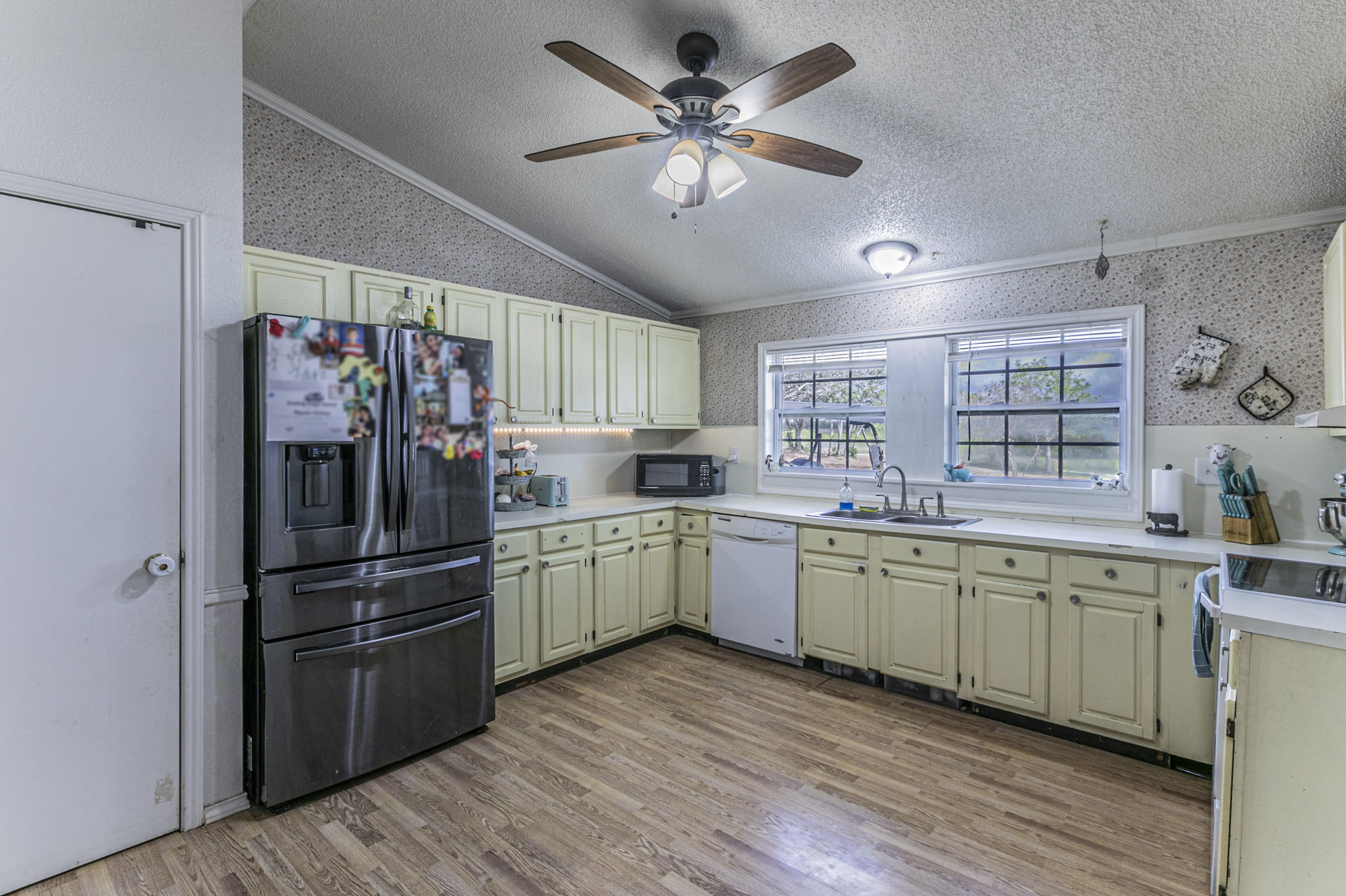 1767 Dowdy Road Seguin, TX 78155 - Photo 7 of 25 a kitchen with stainless steel appliances a sink cabinets and wooden floor