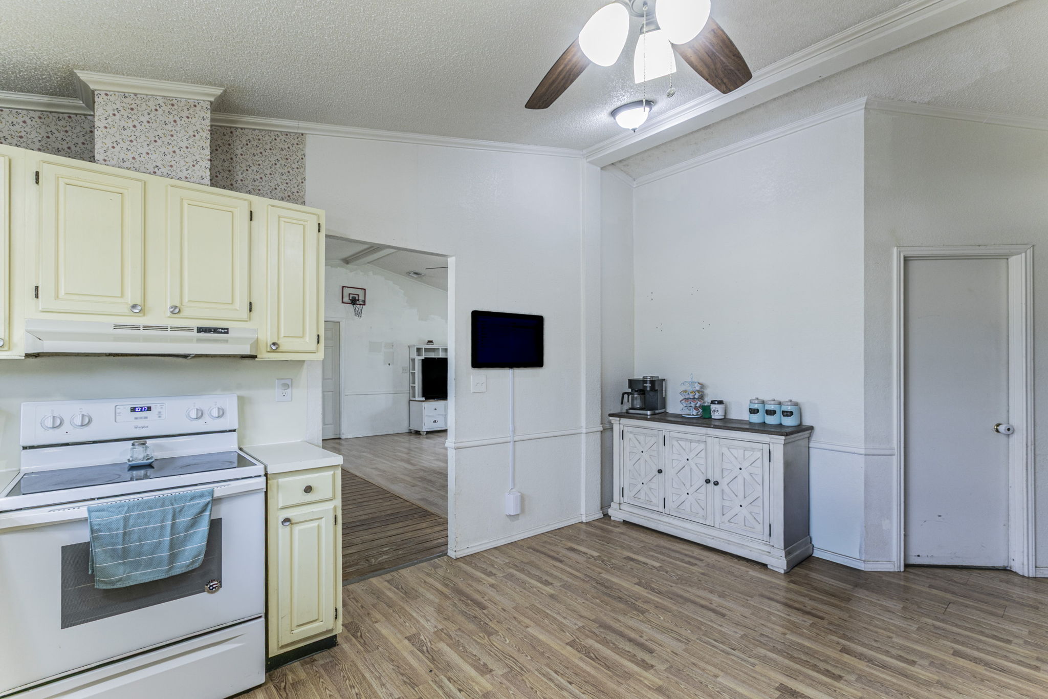 1767 Dowdy Road Seguin, TX 78155 - Photo 9 of 25 a kitchen with stainless steel appliances white cabinets and wooden floor