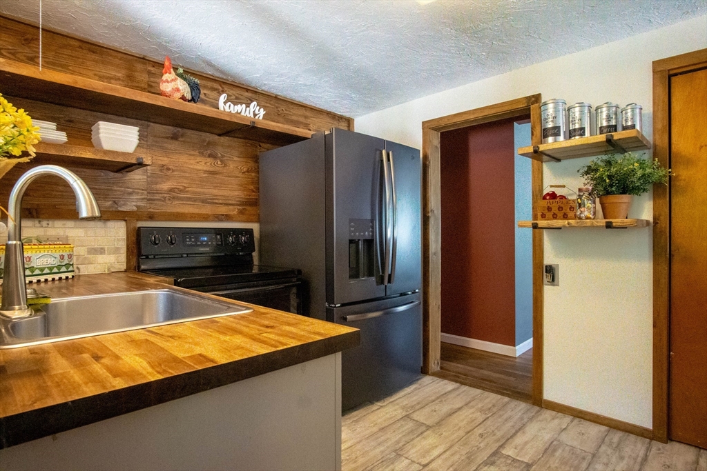 56 Chace Road East Freetown, MA 02717 - Photo 20 of 39 a kitchen with stainless steel appliances granite countertop a refrigerator and a sink