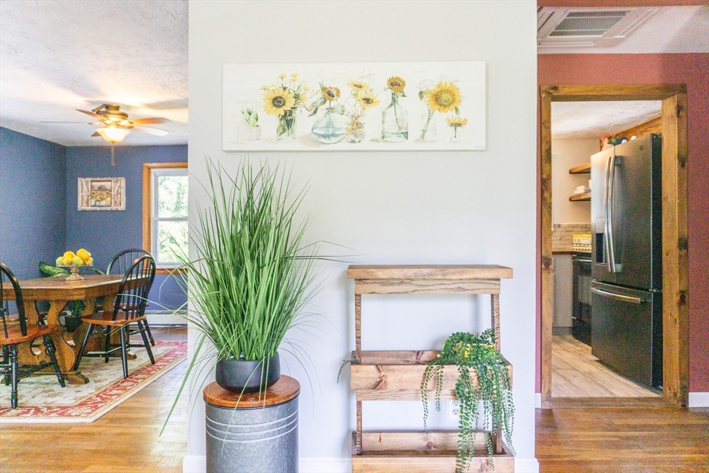 56 Chace Road East Freetown, MA 02717 - Photo 6 of 39 a vase of flowers sitting on a table with a potted plant