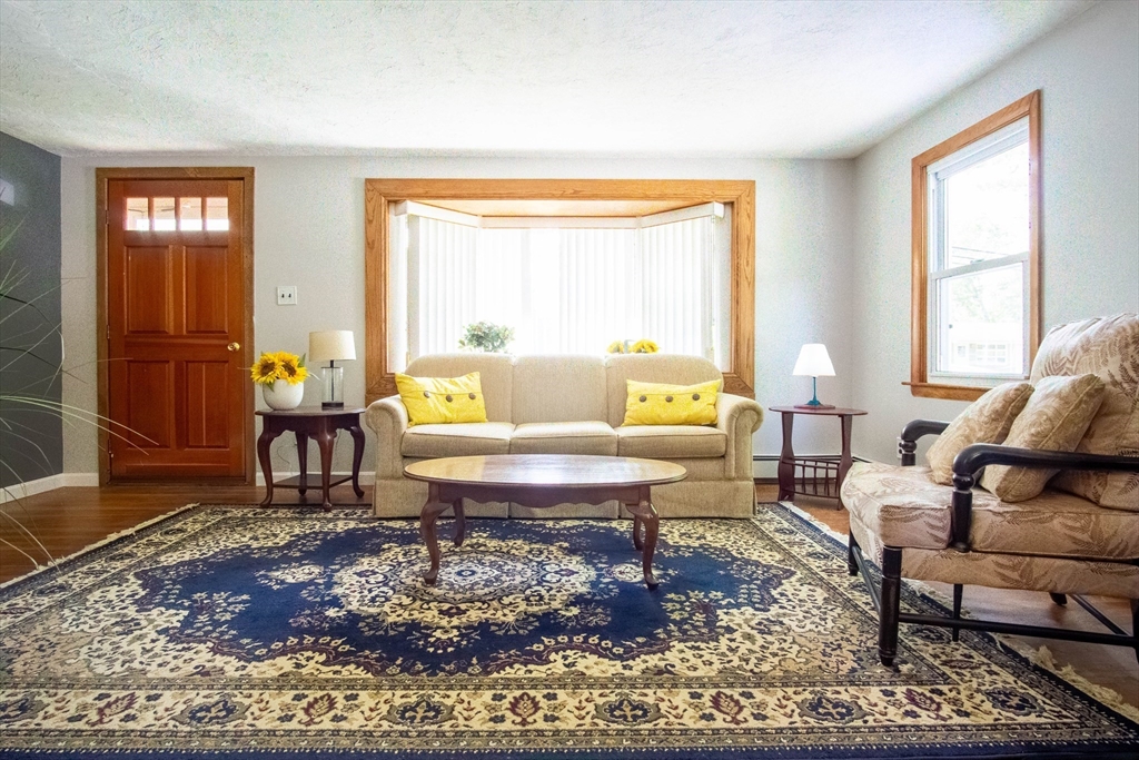 56 Chace Road East Freetown, MA 02717 - Photo 9 of 39 a living room with furniture a rug and a large window