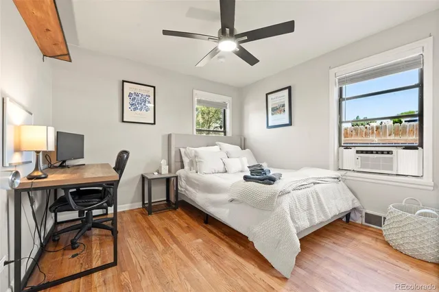 a bedroom with a bed and a desk