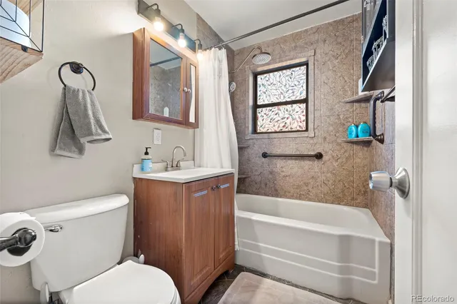 a bathroom with a toilet sink and tub