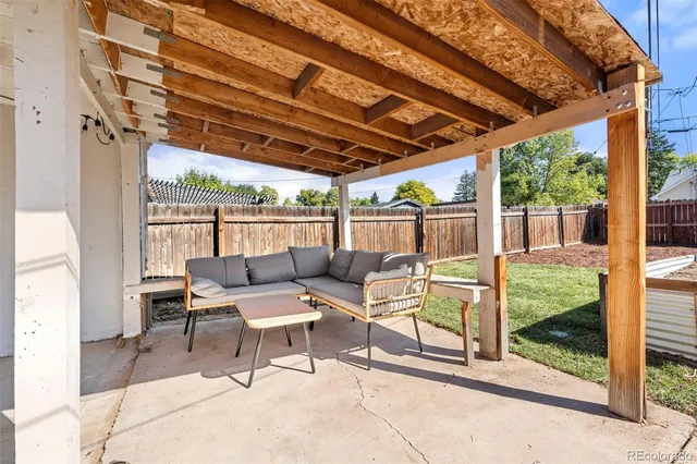 a building outdoor space with patio furniture and garden view