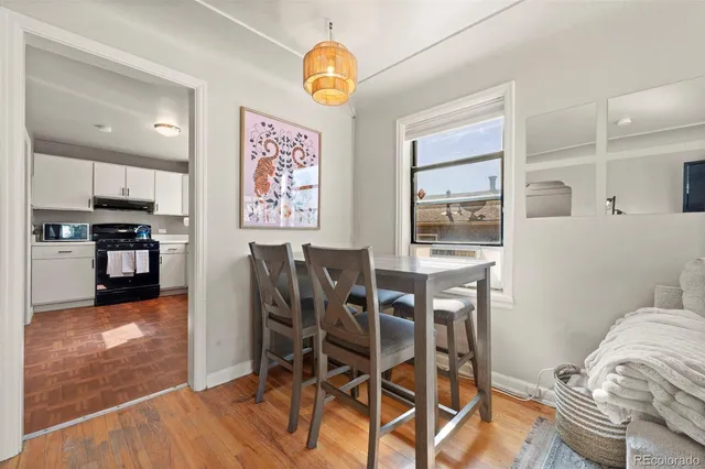 a view of a dining room with furniture and wooden floor