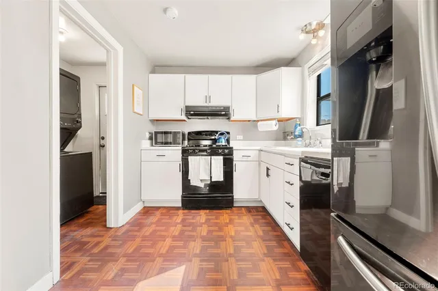 a kitchen with stainless steel appliances granite countertop a refrigerator a stove top oven a sink and dishwasher