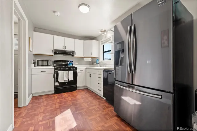 a kitchen with stainless steel appliances a refrigerator sink and cabinets