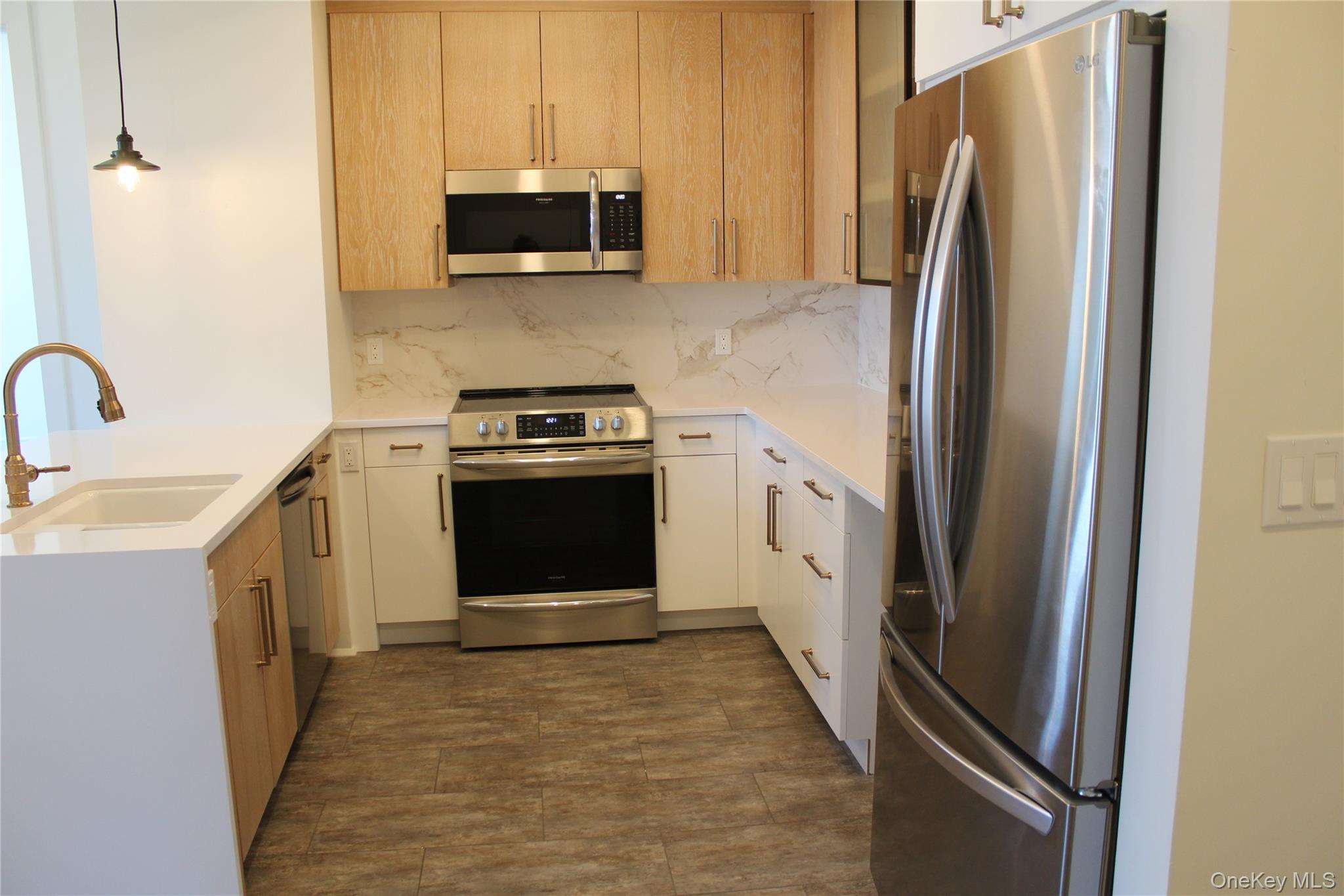 331 East Main Street Riverhead, NY 11901 - Photo 2 of 6 a kitchen with stainless steel appliances a refrigerator stove and microwave