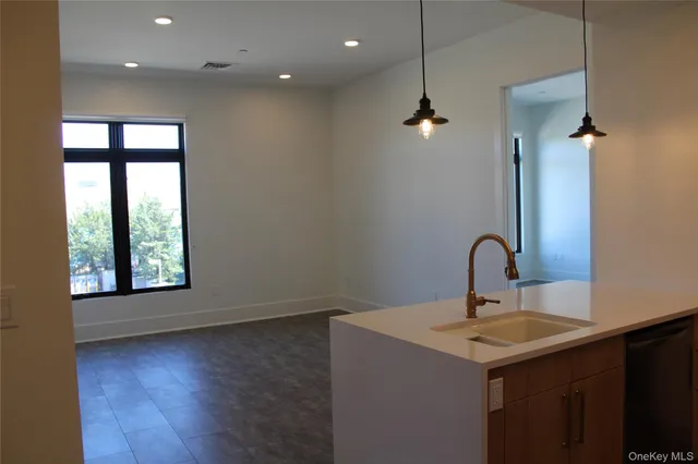 a bathroom with a sink a window and a mirror