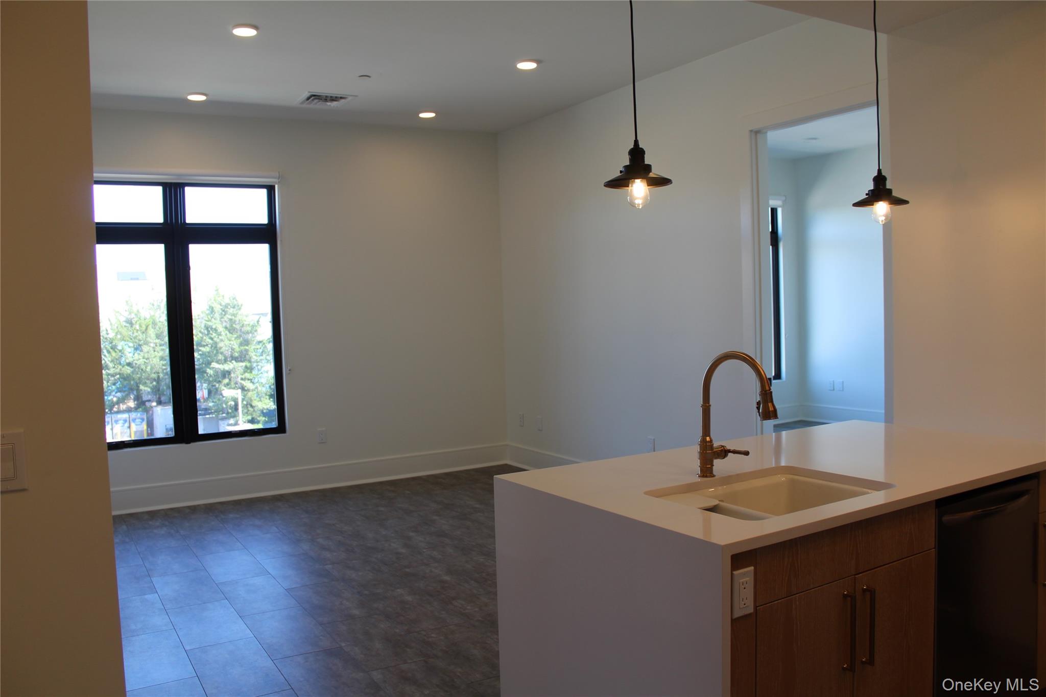 331 East Main Street Riverhead, NY 11901 - Photo 3 of 6 a bathroom with a sink a window and a mirror