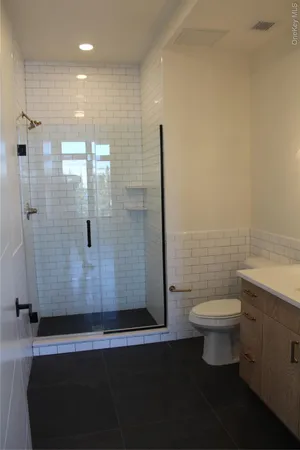 a bathroom with a toilet and a shower