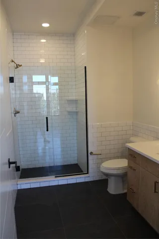 a bathroom with a toilet and a shower