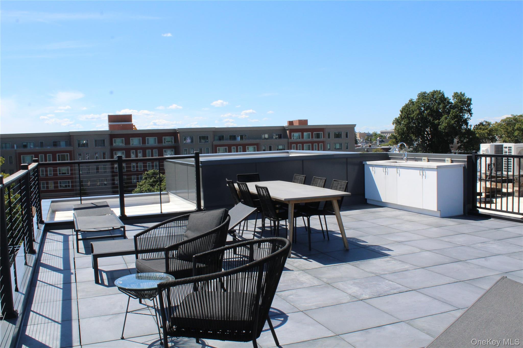 331 East Main Street Riverhead, NY 11901 - Photo 5 of 6 a terrace with outdoor seating and city view