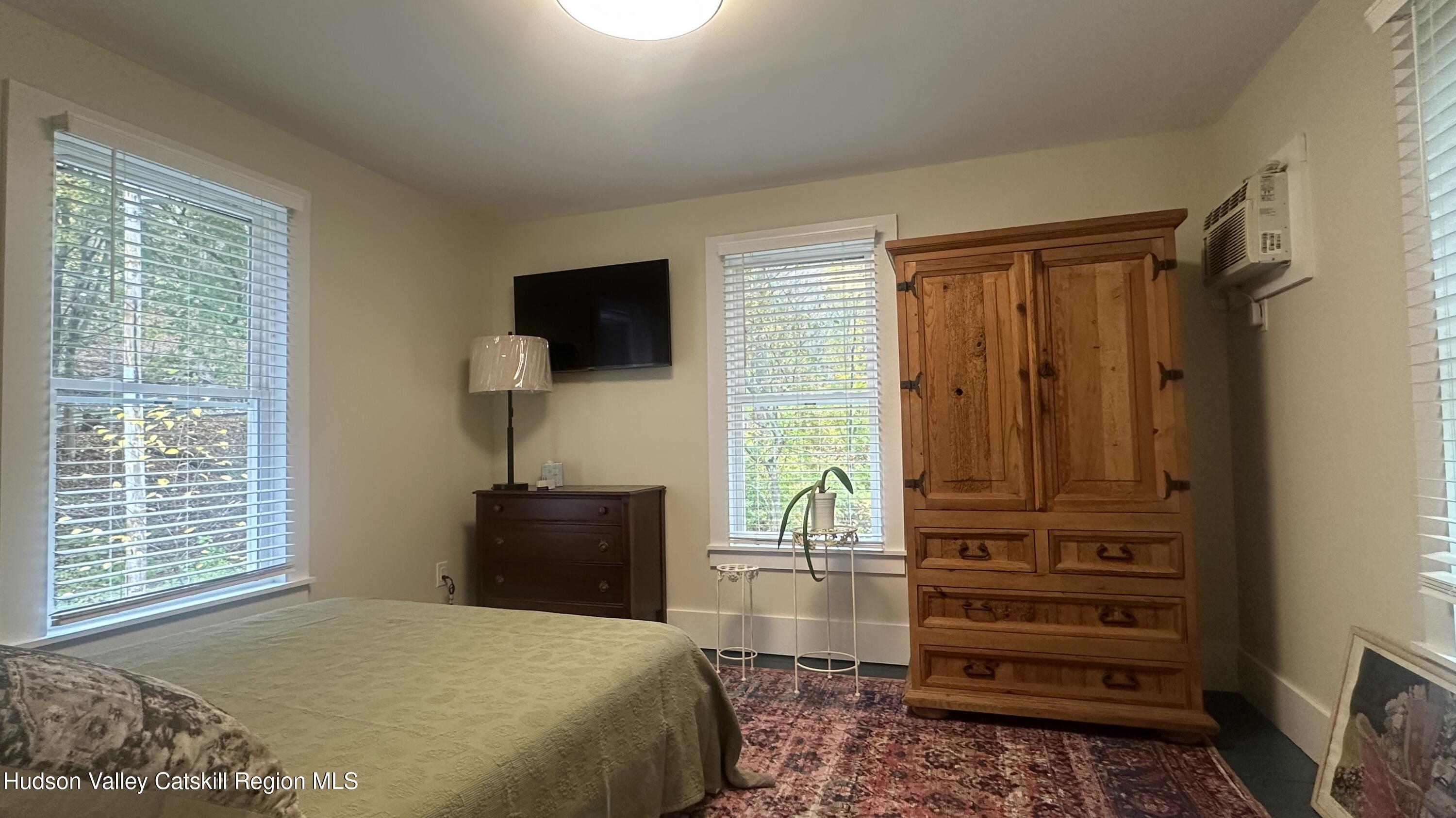 7 River Road, Unit TOWN ROAD Highland, NY 12528 - Photo 16 of 25 a bedroom with a bed and a television