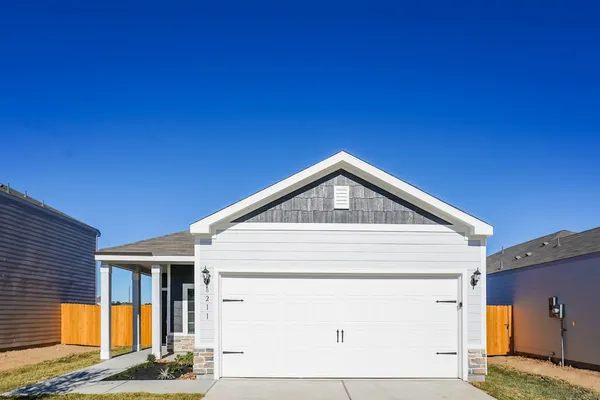 a front view of a house with garden