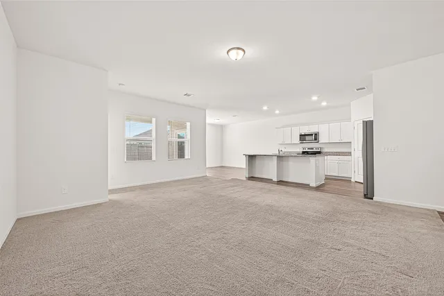 a view of a kitchen with a sink and a refrigerator