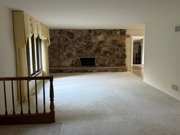 a view of a porch with wooden floor and staircase