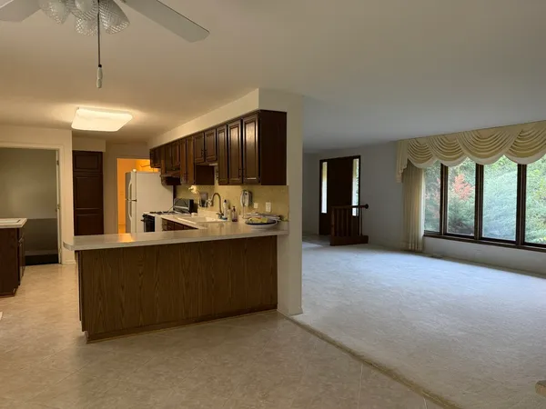 a view of living room with furniture and a kitchen