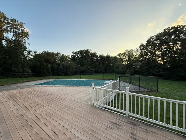 a view of deck with chair and wooden floor