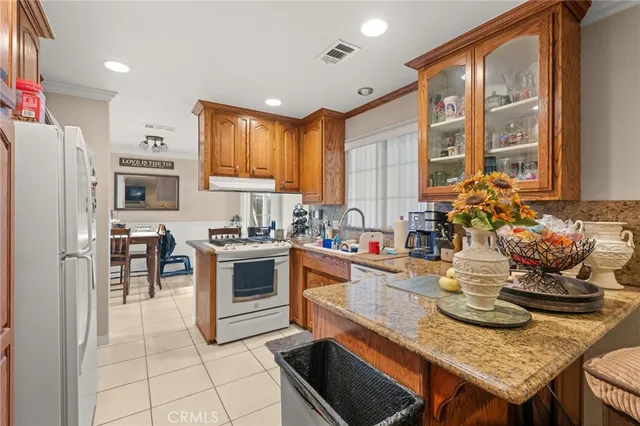 a kitchen with a stove a sink and a refrigerator