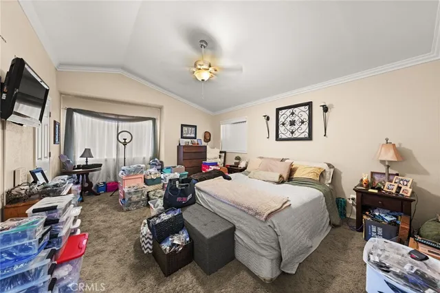 a bedroom with bed a mirror and desk