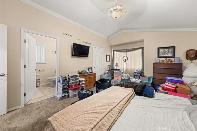 a bedroom with furniture and a flat screen tv