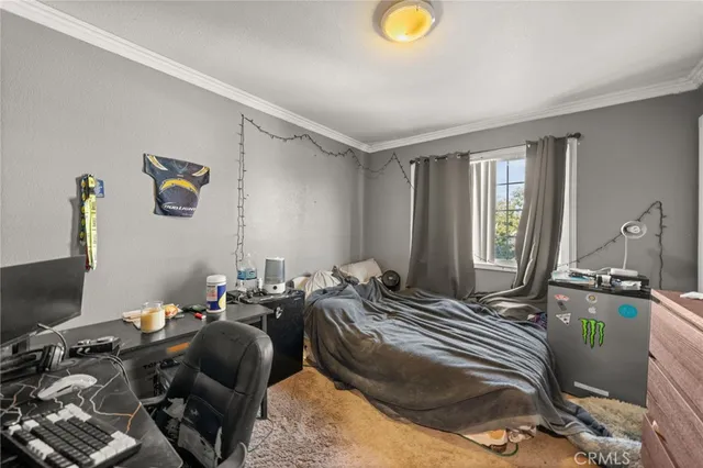 a bedroom with two beds and a window