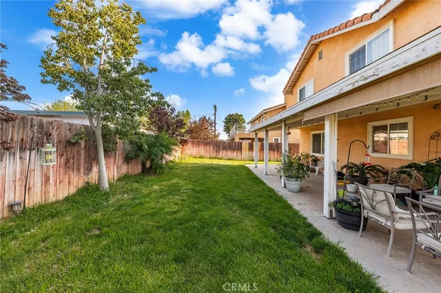 a view of a backyard with sitting area and garden
