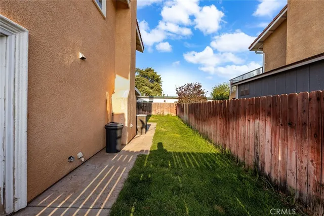 a view of a backyard with wooden fence