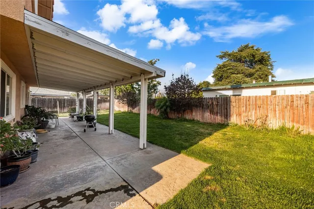 a view of a patio with table and chairs potted plants with wooden fence