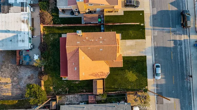 an aerial view of a house with a yard basket ball court and outdoor seating
