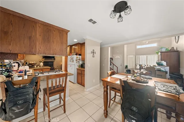a kitchen with a table chairs stove and refrigerator