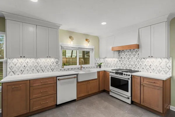 a kitchen with white cabinets and white appliances