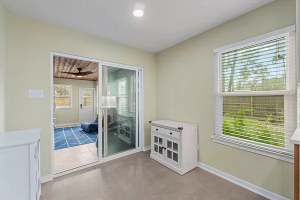 a view of a hallway with an empty room and window