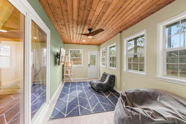 a living room with furniture and a floor to ceiling window