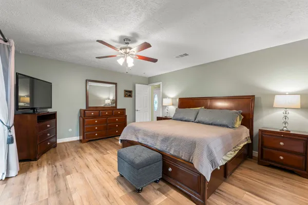 a bedroom with a bed and a flat screen tv
