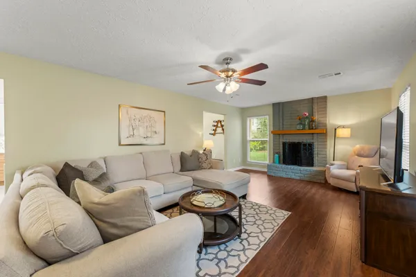 a living room with furniture fireplace and a fireplace