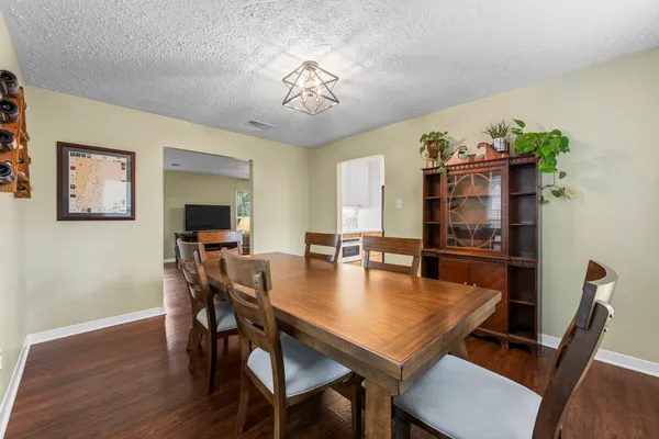 a view of a dining room with furniture and wooden floor