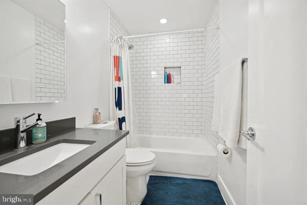 4016 Georgia Avenue Northwest, Unit 4 Washington, DC 20011 - Photo 11 of 13 a bathroom with a granite countertop sink toilet and shower