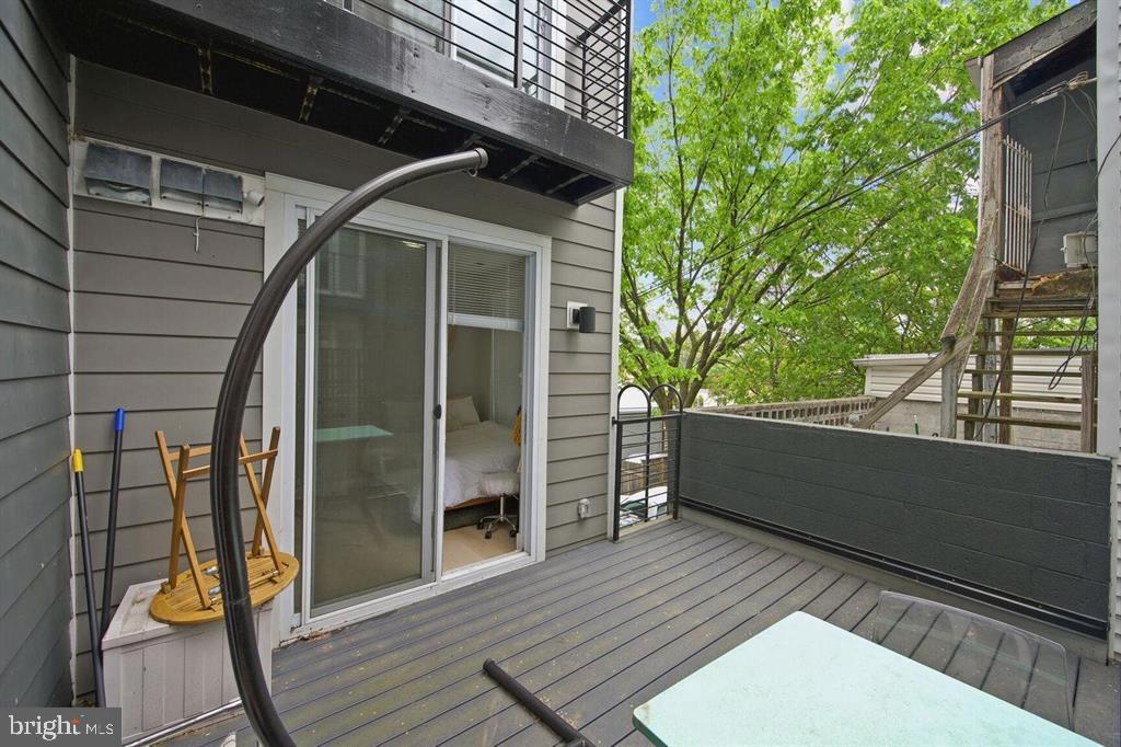 4016 Georgia Avenue Northwest, Unit 4 Washington, DC 20011 - Photo 13 of 13 a view of a balcony with wooden floor and iron stairs